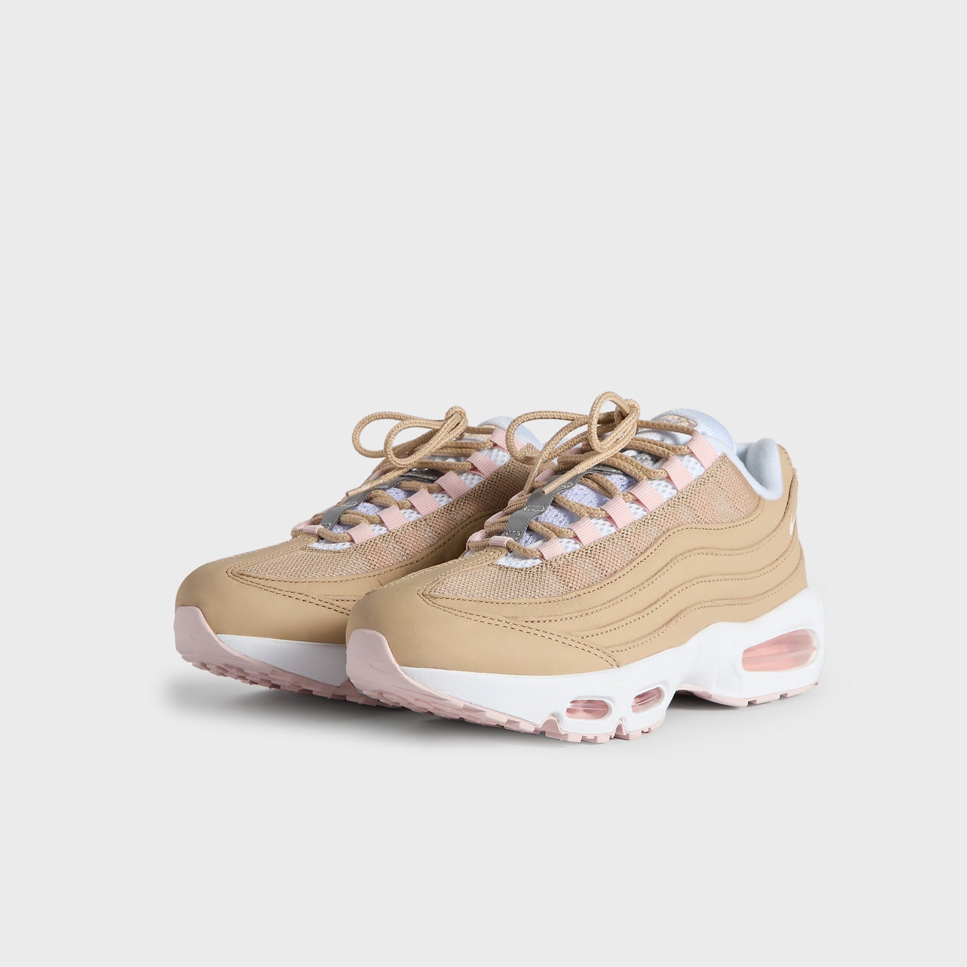 Kith Kids x Nike GS Air Max 95 Linen pair angled from the front, linen upper with pink accents and tan laces (additional studio view)
