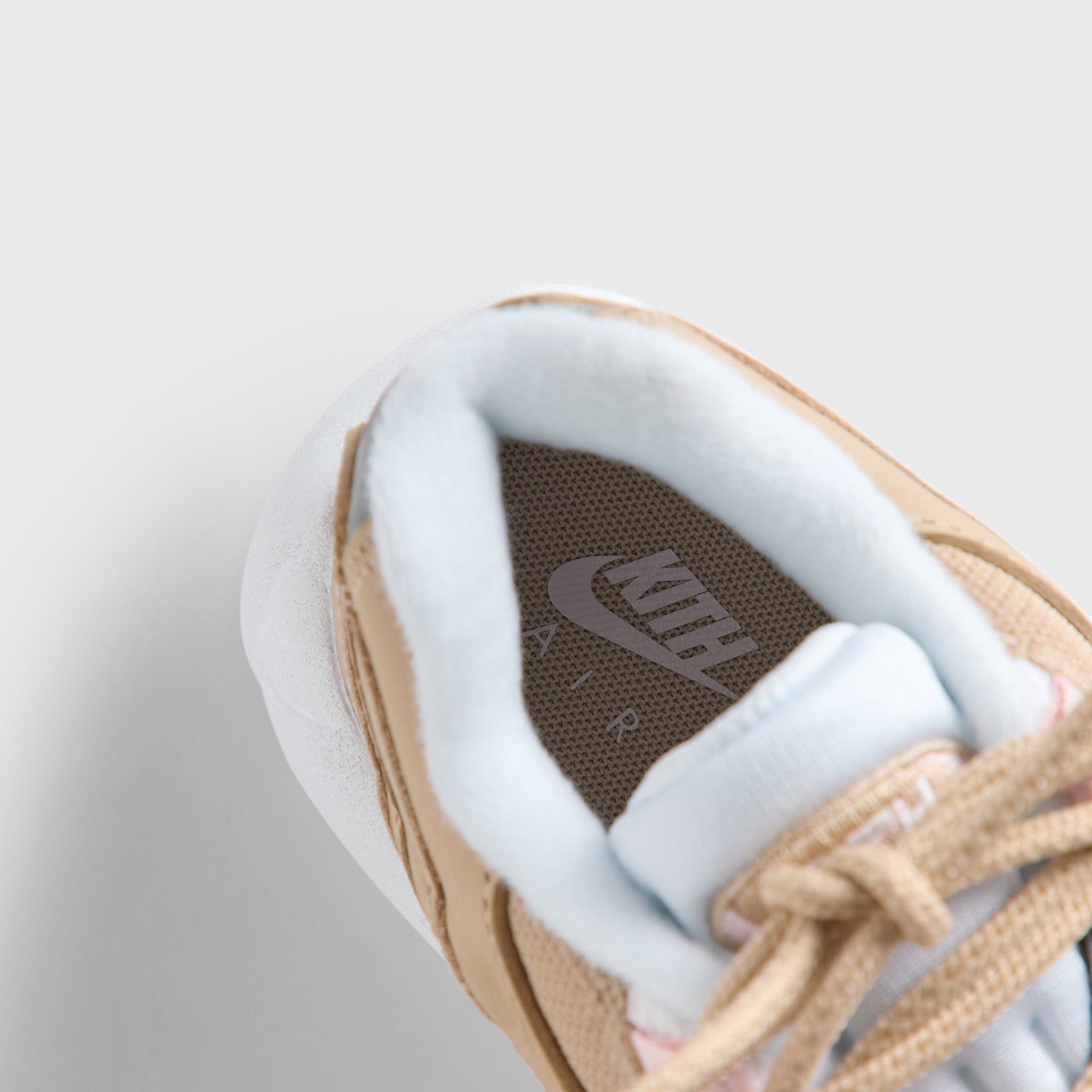 Footbed of the Kith Kids x Nike PS Air Max 95 Linen with Kith insole branding and blue lining (additional studio view)
