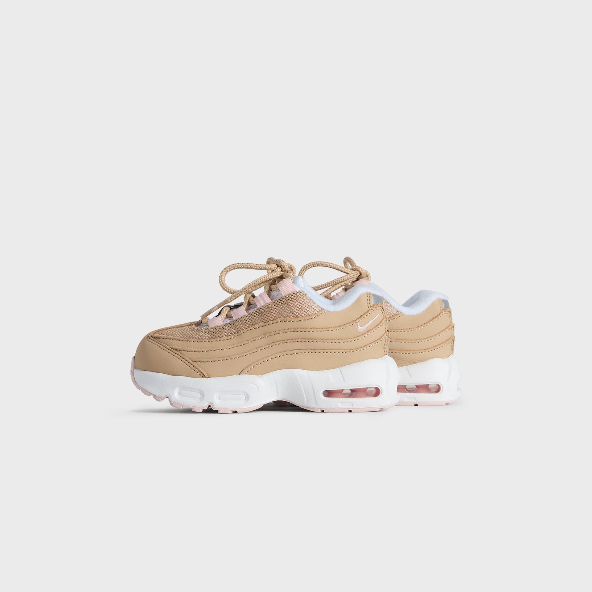 Kith Kids x Nike TD Air Max 95 Linen pair, small front three-quarter angle in wheat linen with pink