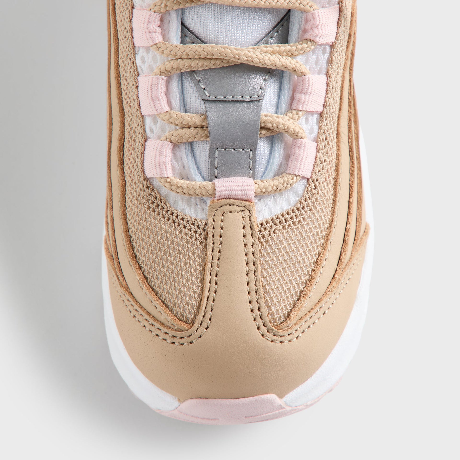 Close-up of the Kith Kids x Nike TD Air Max 95 Linen laced tongue, pink panels and light-blue lining