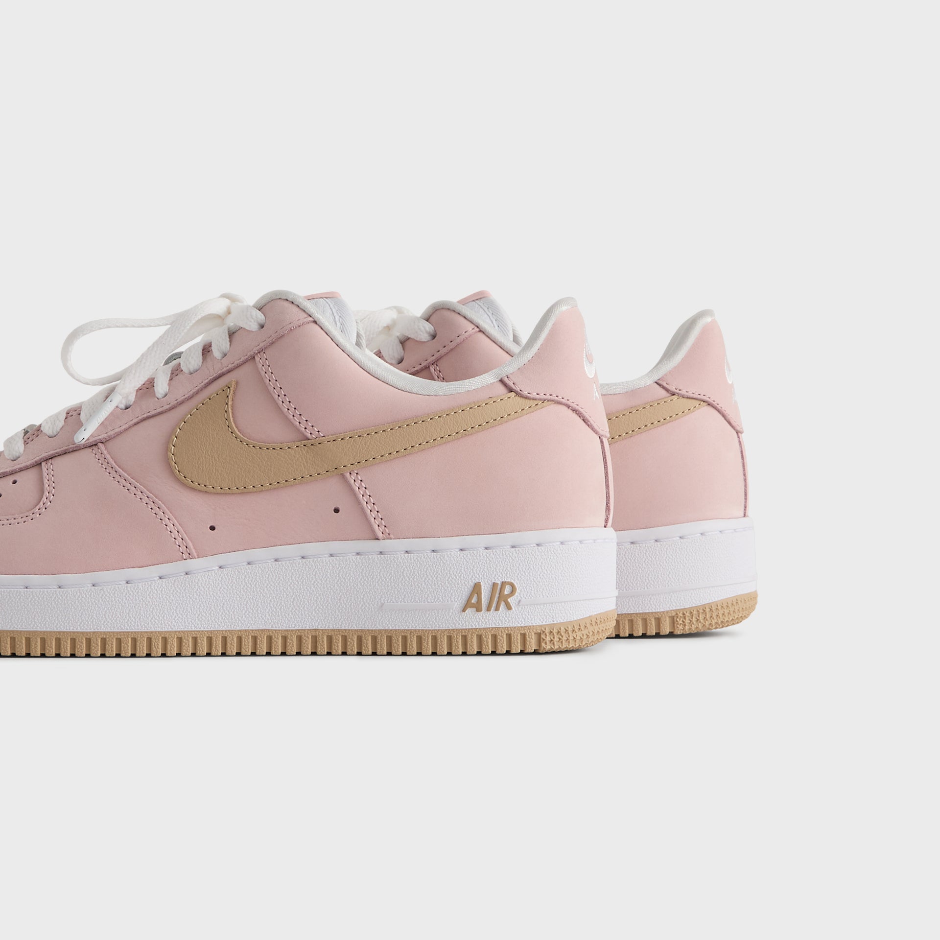 Kith x Nike Air Force 1 Un-Linen pair viewed from the heel and outer side on gum soles