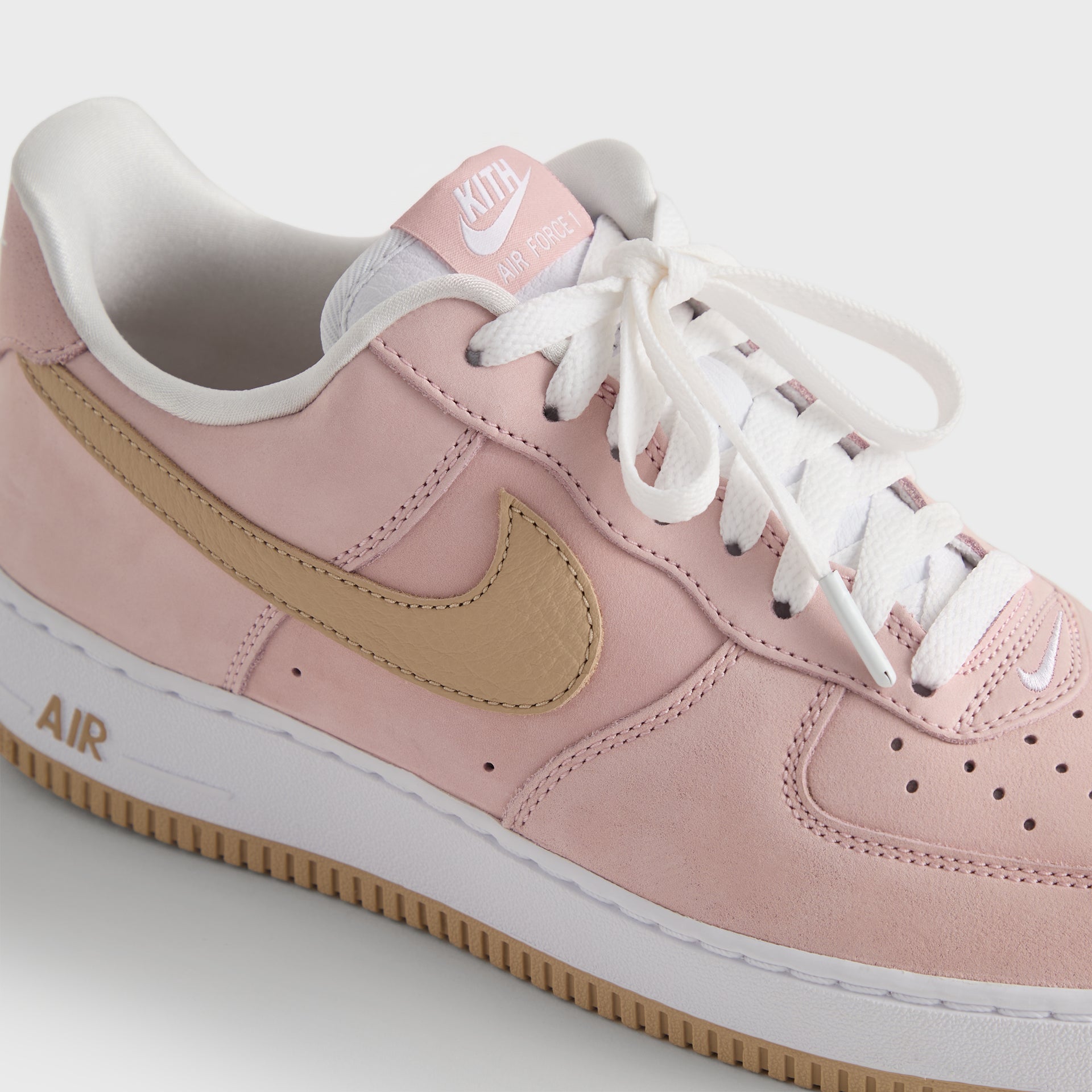 Three-quarter rear detail of the Kith x Nike Air Force 1 Un-Linen, wheat Swoosh and AIR midsole text