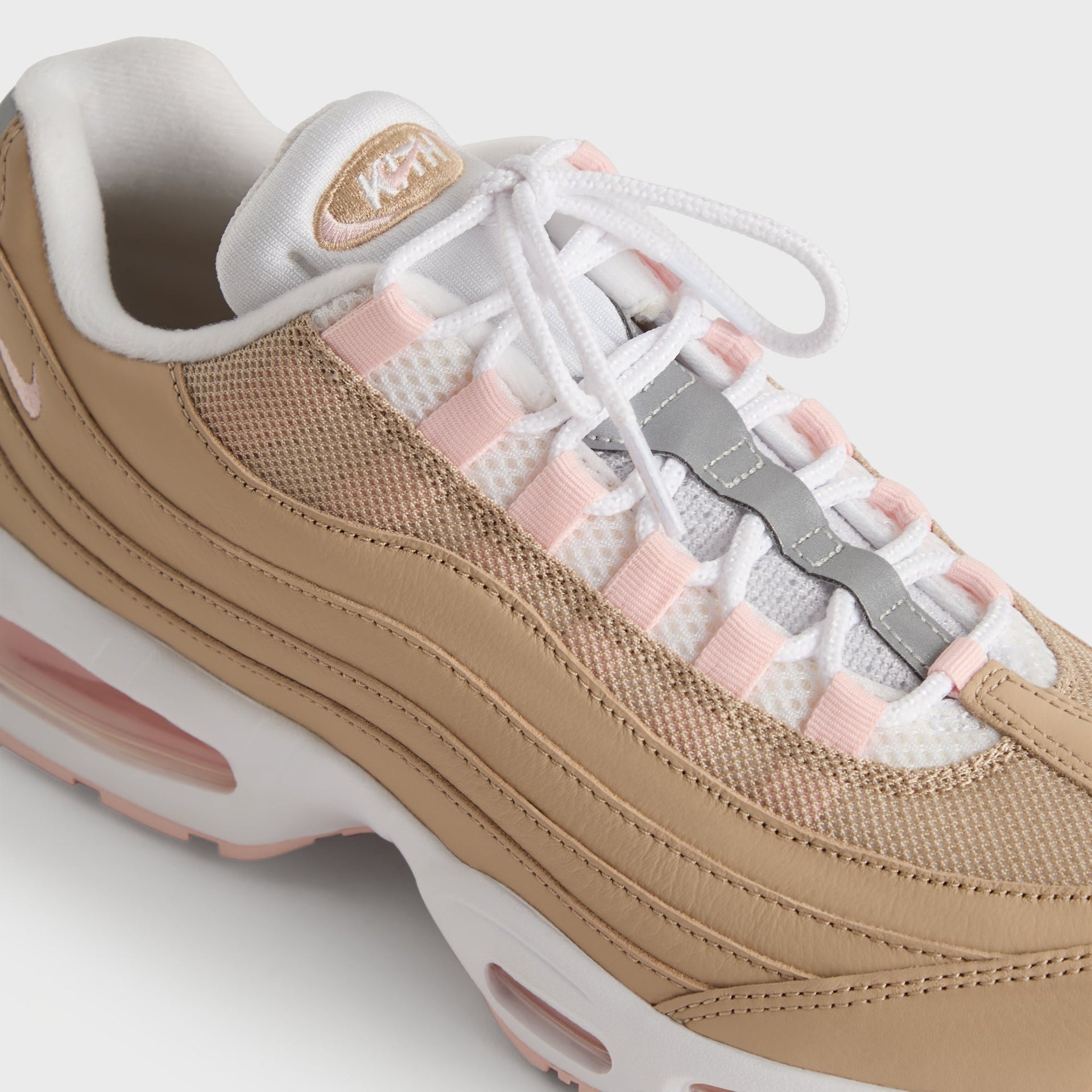 Kith for Nike Air Max 95 'Linen' lateral lace close-up with grey Nike flap, pink eyelets and Air unit