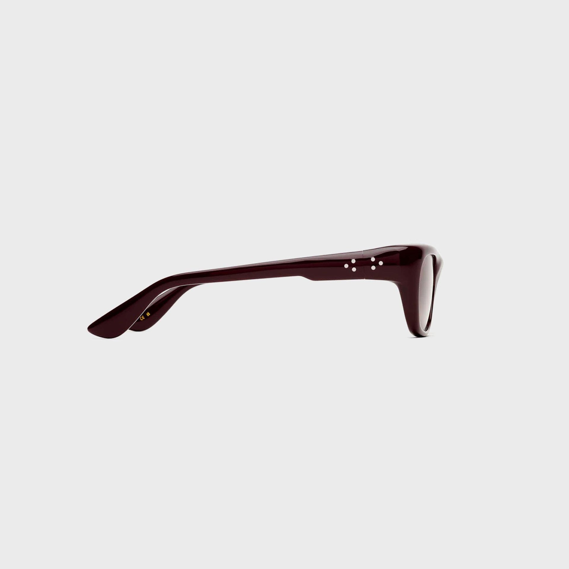 Port Tanger Dil burgundy sunglasses, side temple profile showing signature dot rivets