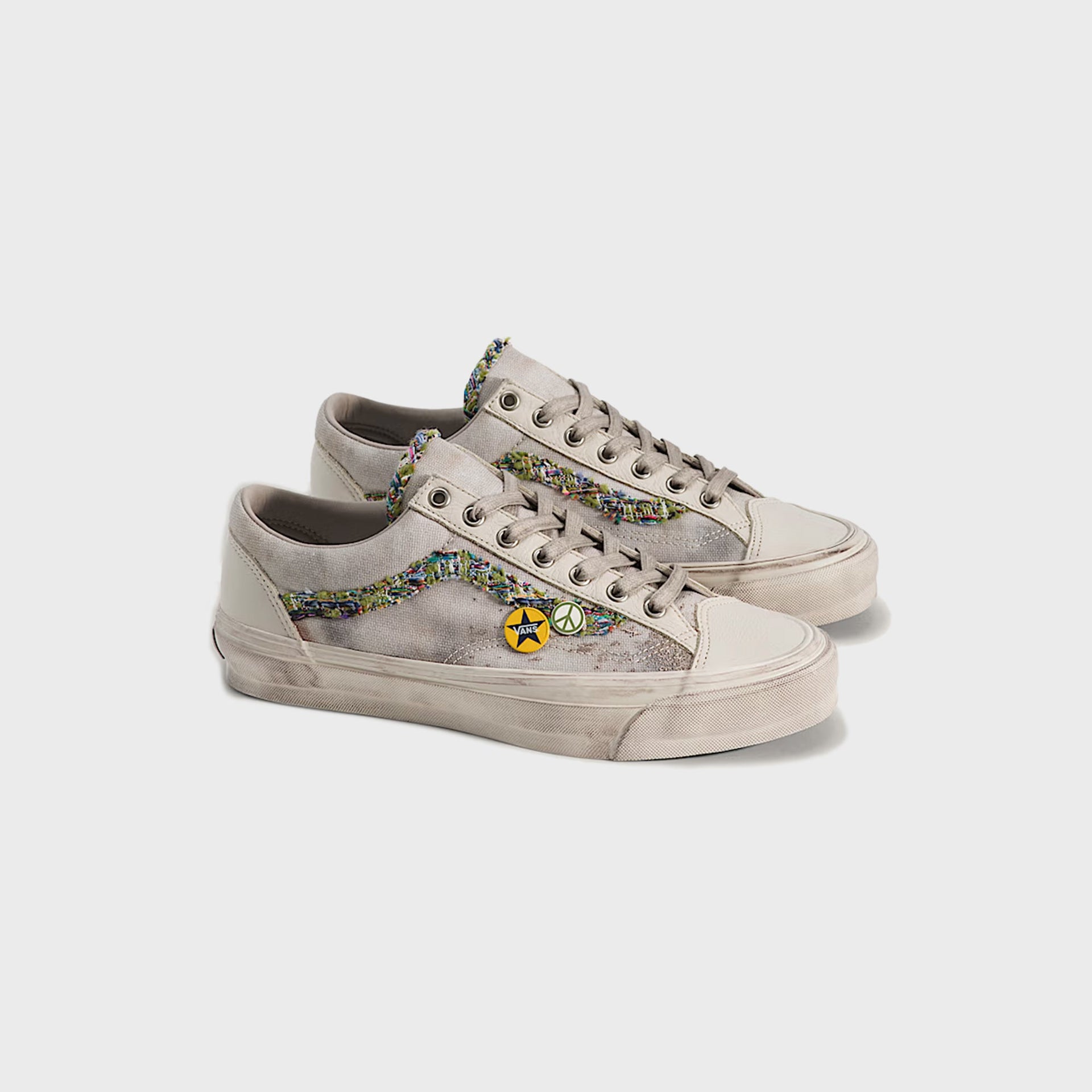 Vans LX Old Skool 36 sneakers in oatmeal beige, angled front three-quarter view of the pair with colorful bouclé sidestripes