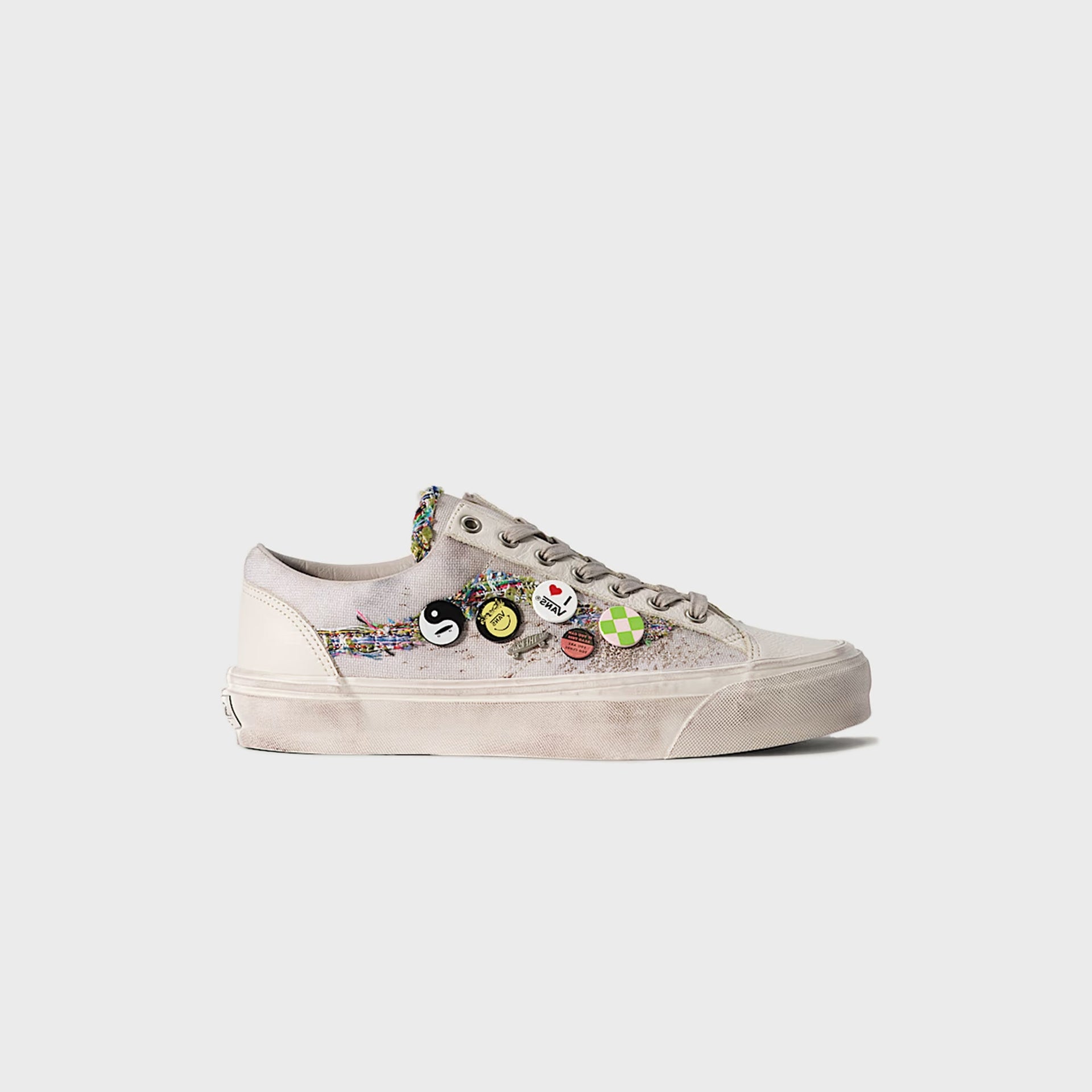 Vans LX Old Skool 36 in oatmeal beige, lateral profile of one washed-canvas sneaker with tweed sidestripe and enamel pin badges
