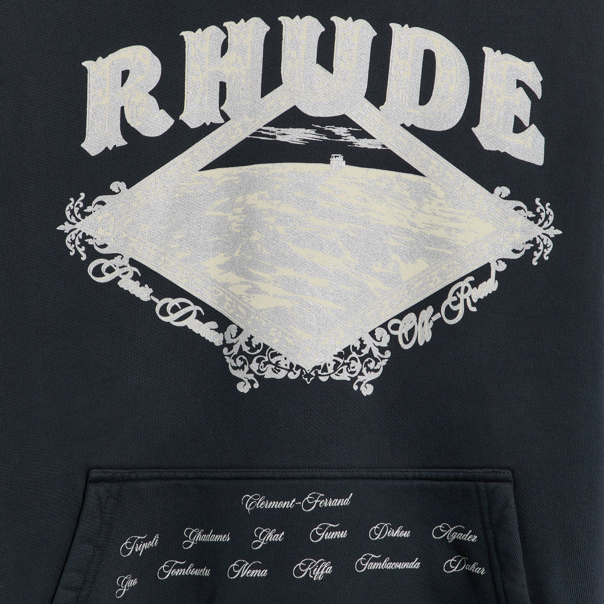 Rhude Dakar Convoy hoodie, close-up of silver RHUDE off-road diamond print and city names on pocket