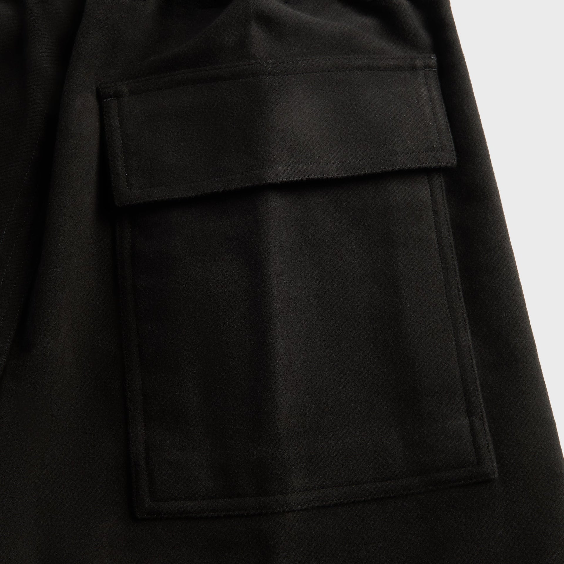 Stone Island compass badge detail, green and yellow embroidery with buttons on black sweatshirt