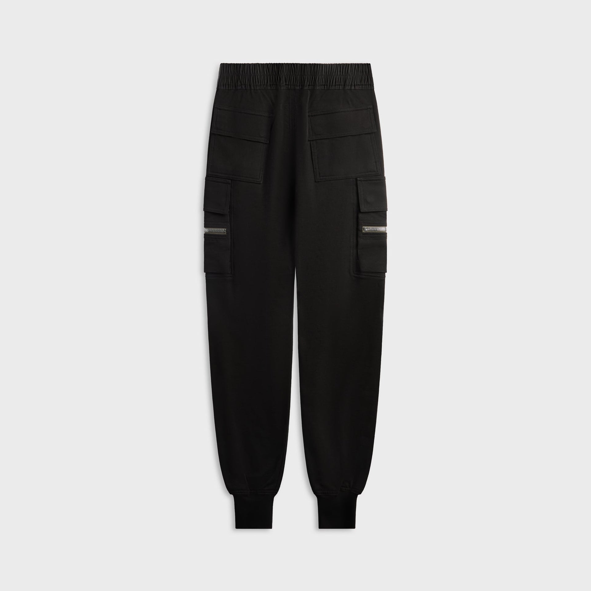 Stone Island black trousers, back view, patch pockets and leather logo tab on waistband