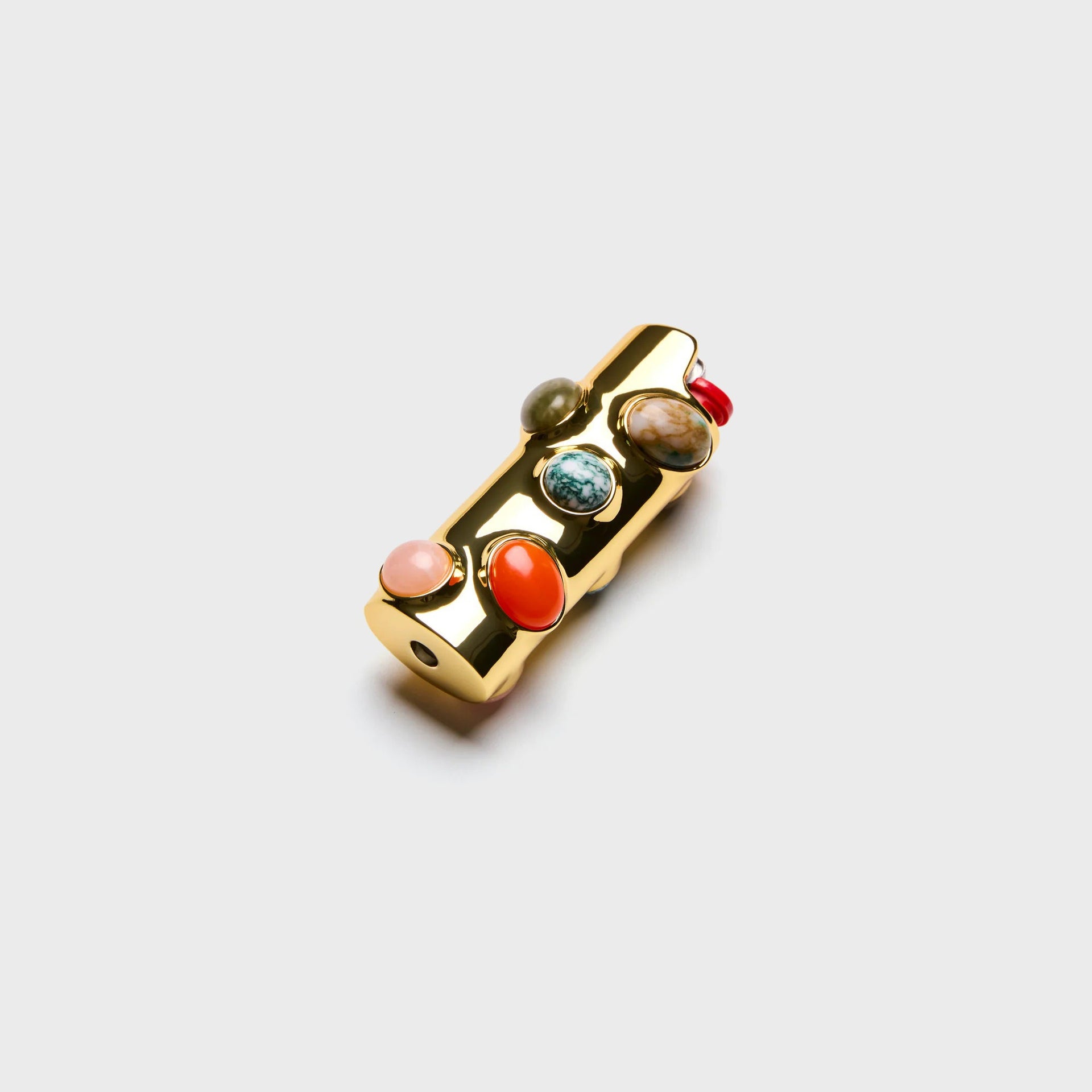 Edie Parker Stoned lighter case, gold case with orange carnelian and multicolor cabochon stones, three-quarter view