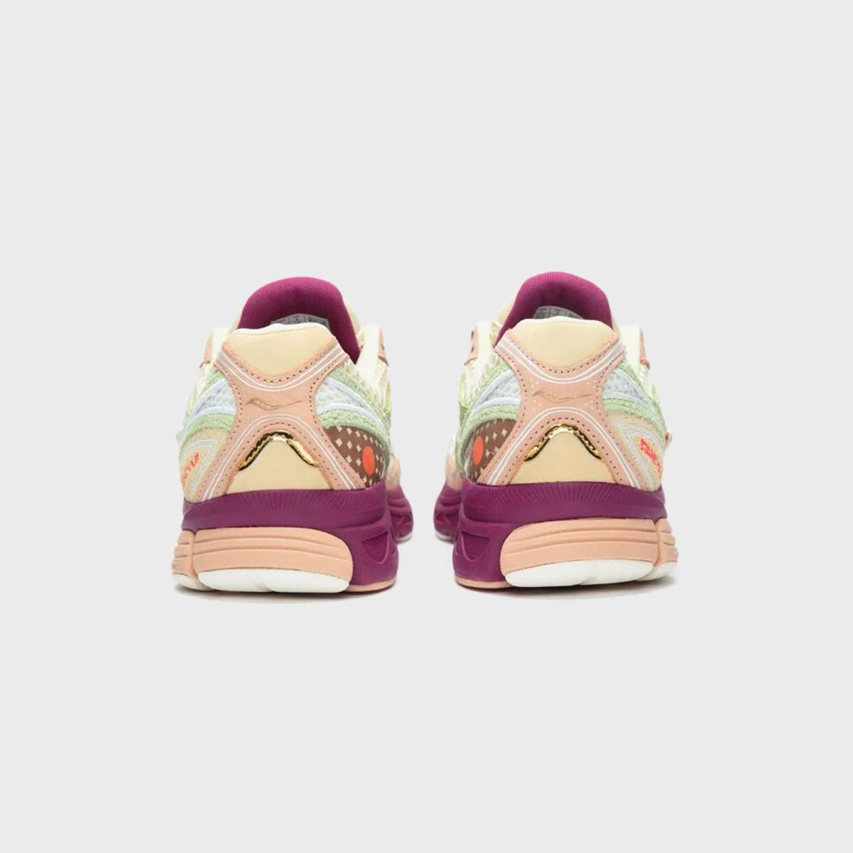 Saucony x Stan Birch ProGrid Guide 7 sneakers rear heel view with mauve pull tabs and cream ankle collars
