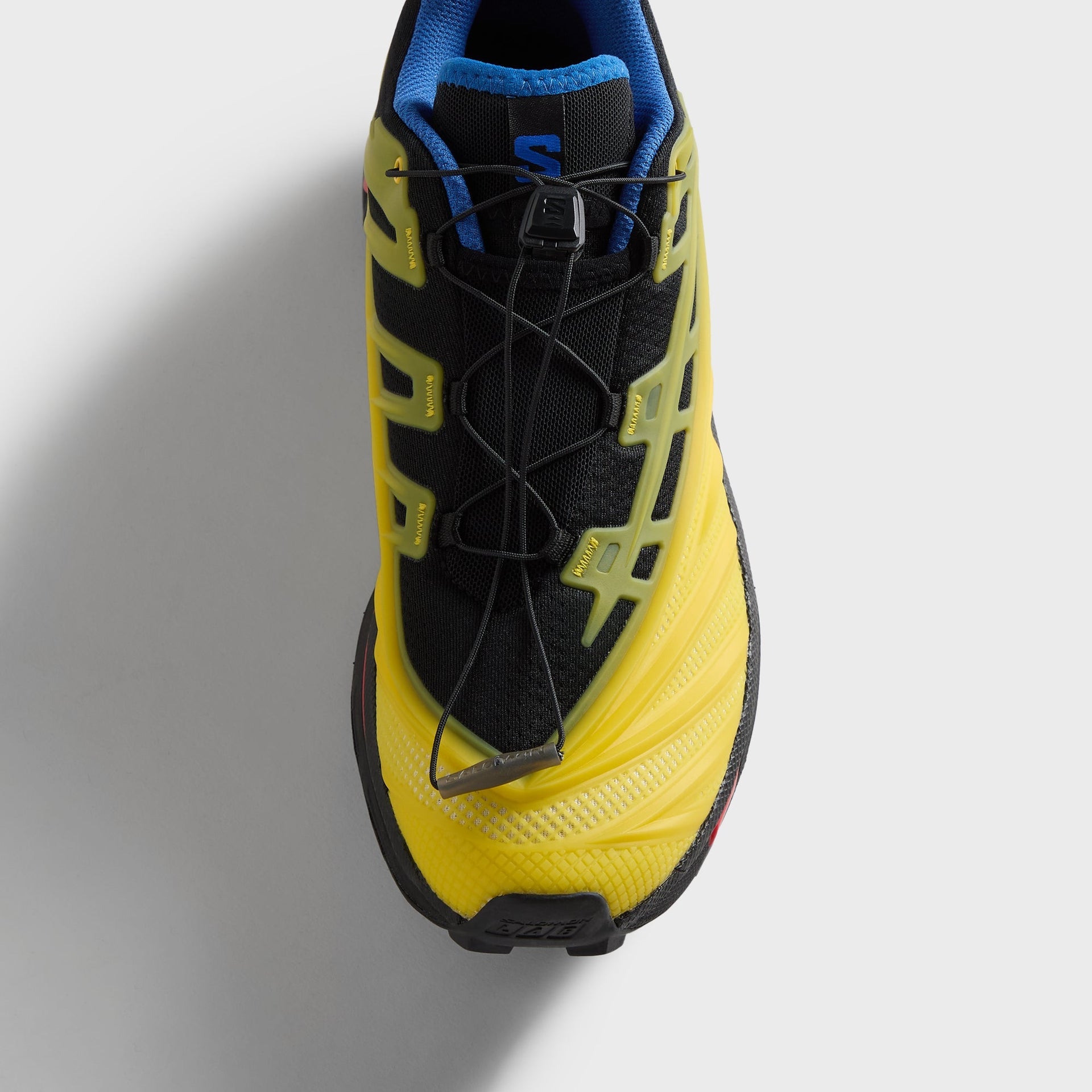 Kith for Salomon XT-EVO, top-down detail of one shoe, quick-lace system and green chassis overlays