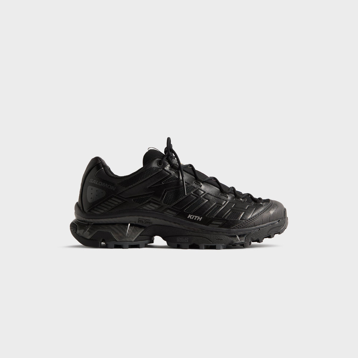 Kith for Salomon XT-4K in Black, lateral profile of the right trail sneaker with dark midsole and Salomon and Kith branding