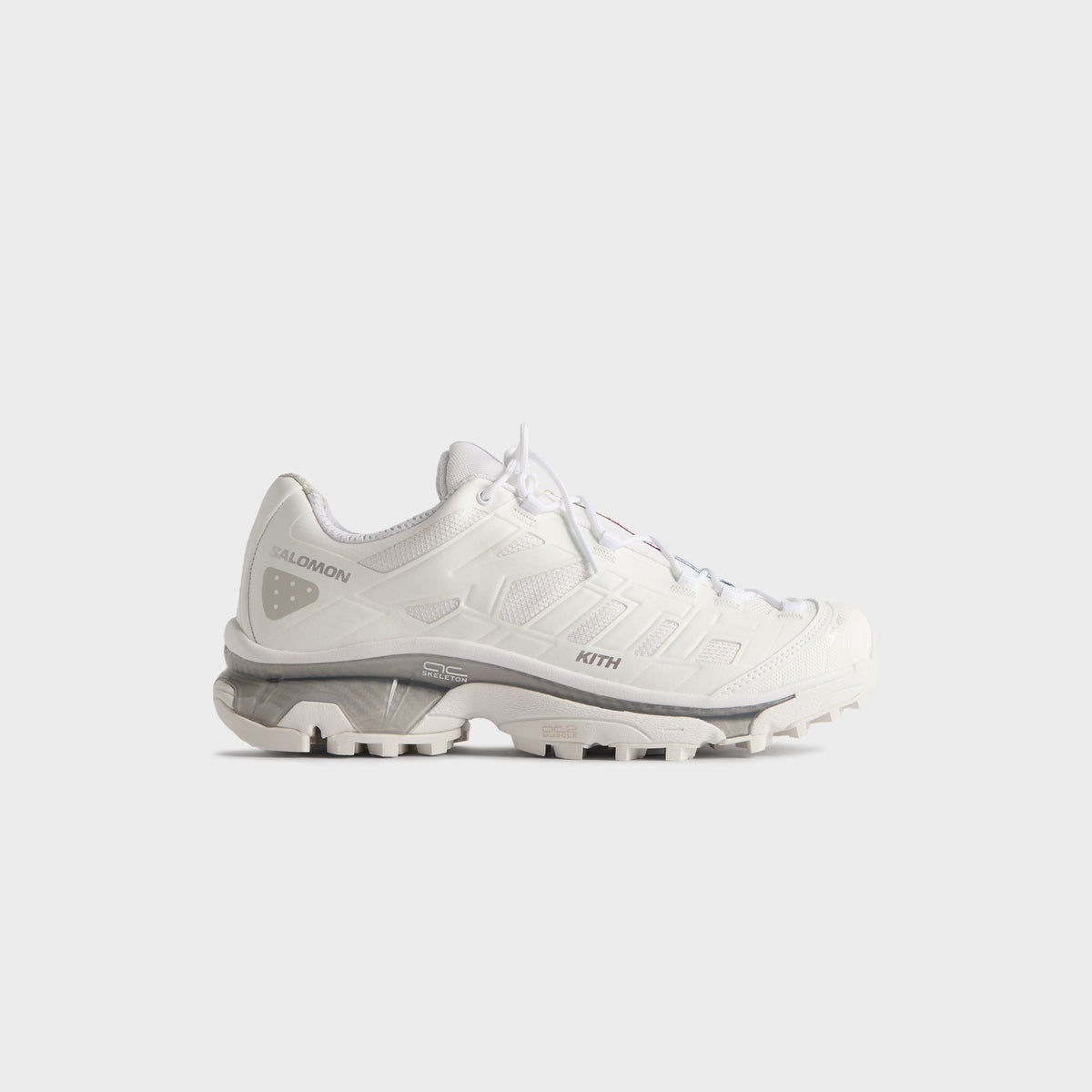 Kith for Salomon XT-4K in White, lateral profile of the right trail sneaker with grey midsole and Salomon and Kith branding