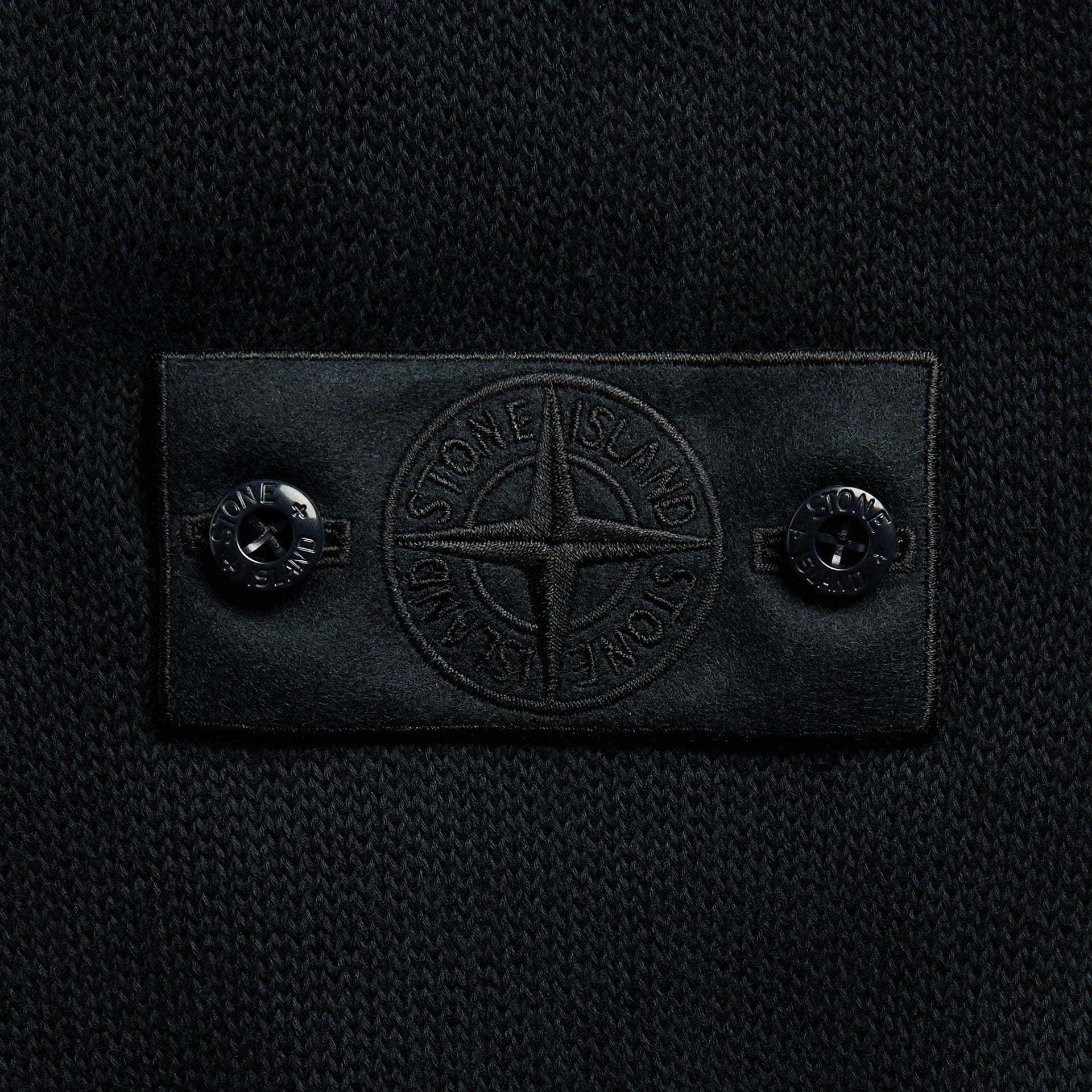 Stone Island Ghost jumper in navy, close-up of tonal compass-rose badge and buttons on knit
