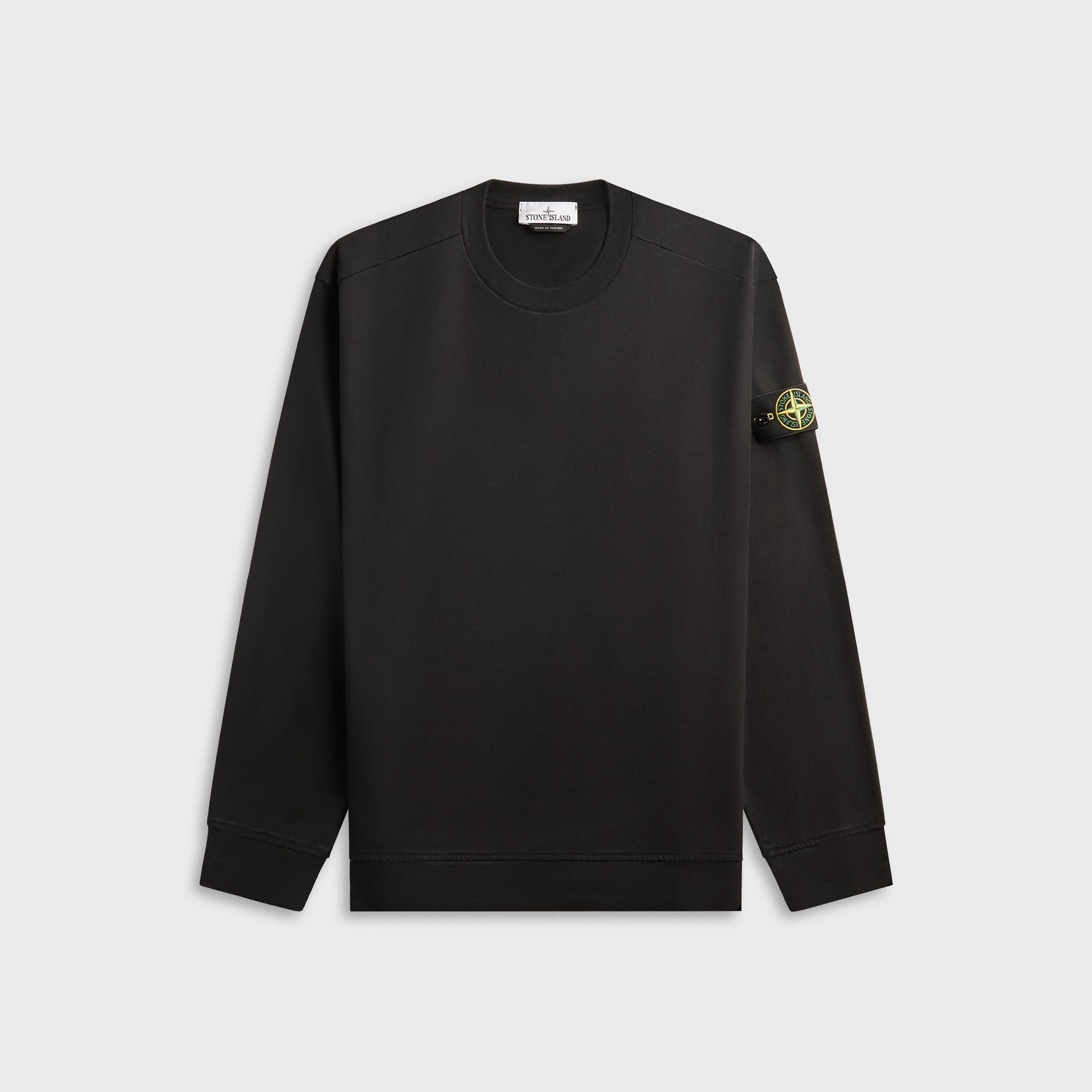 Stone Island heavy organic cotton crewneck sweatshirt in black, front view with compass badge on left sleeve