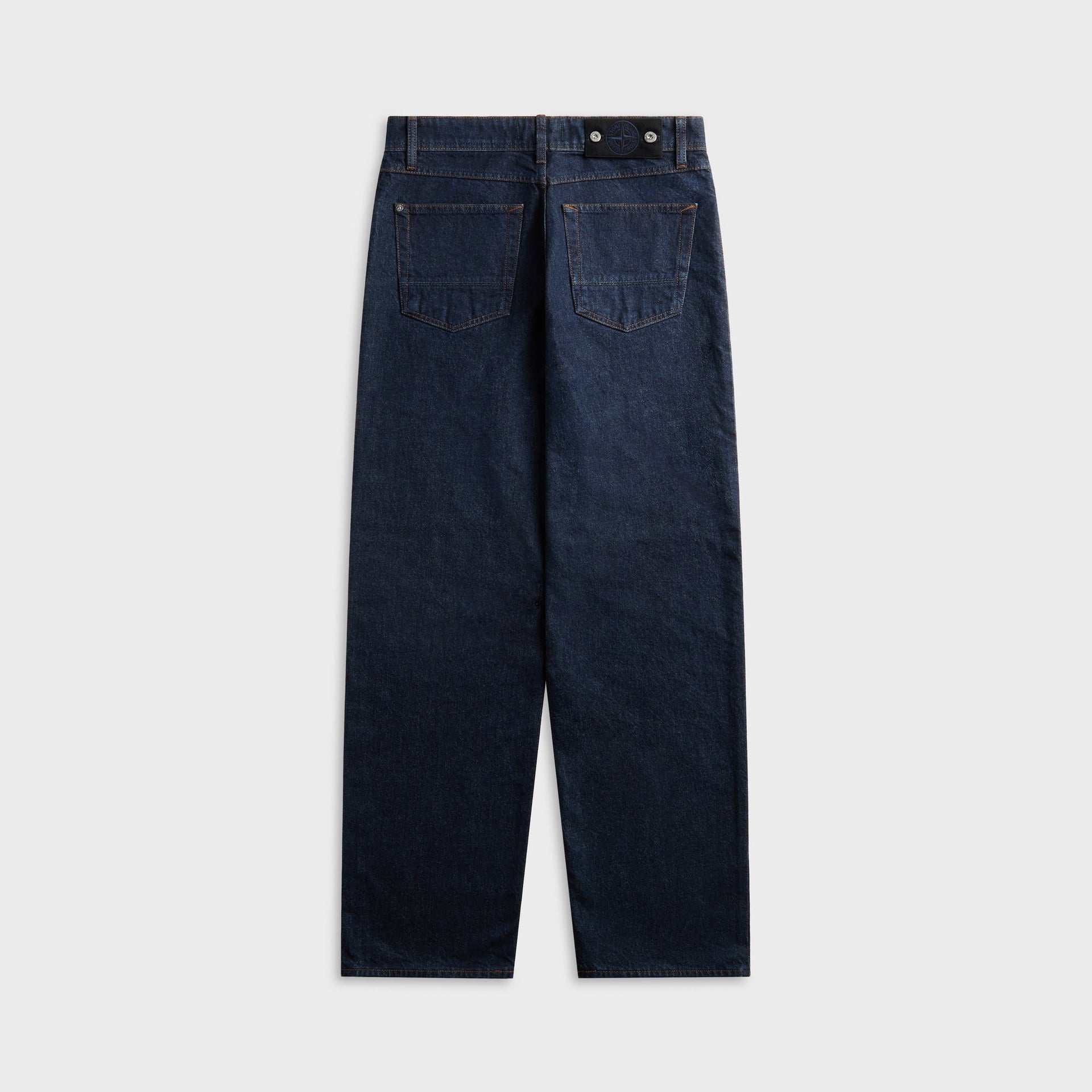 Rinsed indigo Stone Island loose-fit jean, back view with patch pockets and leather waistband tab