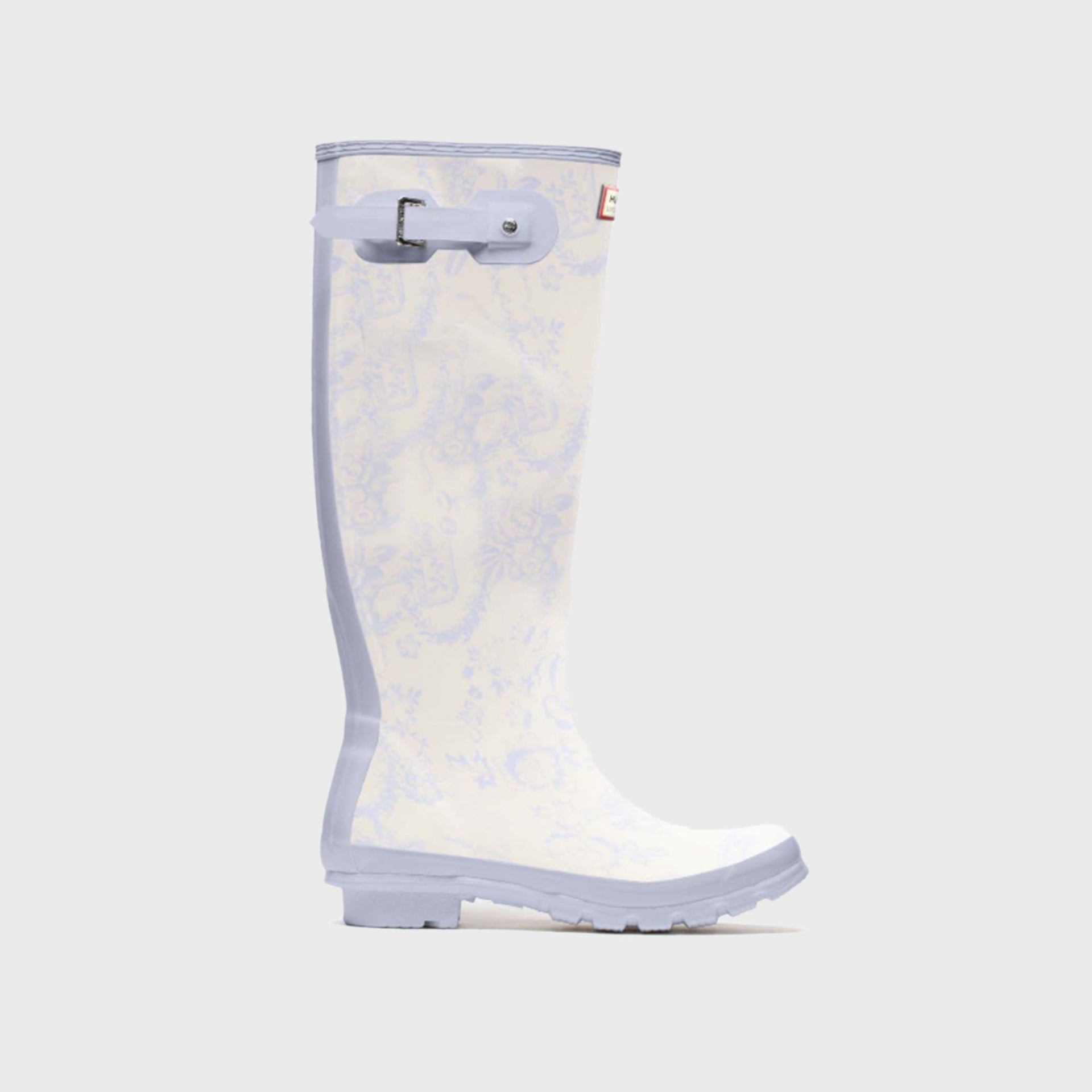 Hunter x LoveShackFancy women's Original Tall rain boot in cream with a soft blue toile floral print and lilac sole, side view