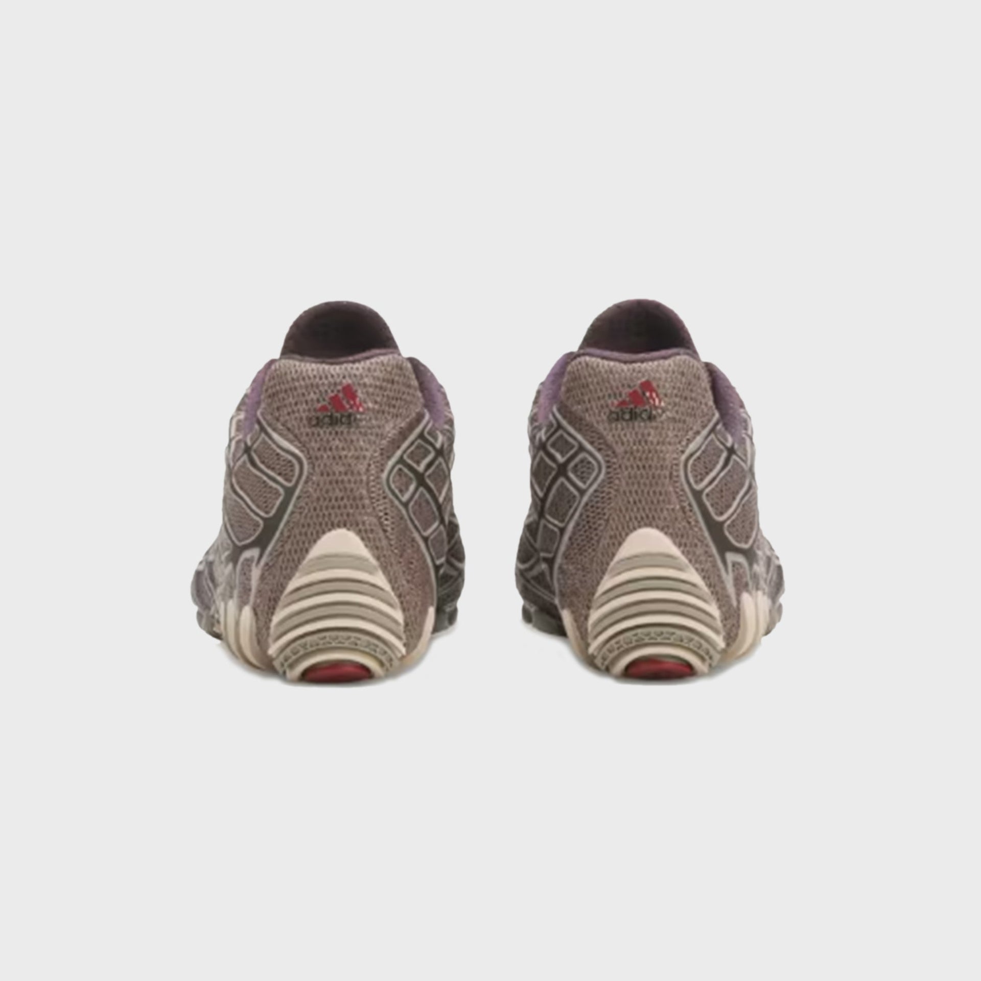 Rear heel view of adidas x Bad Bunny F50 Ghost Sprint sneakers with red adidas logo and ridged cream traction lugs