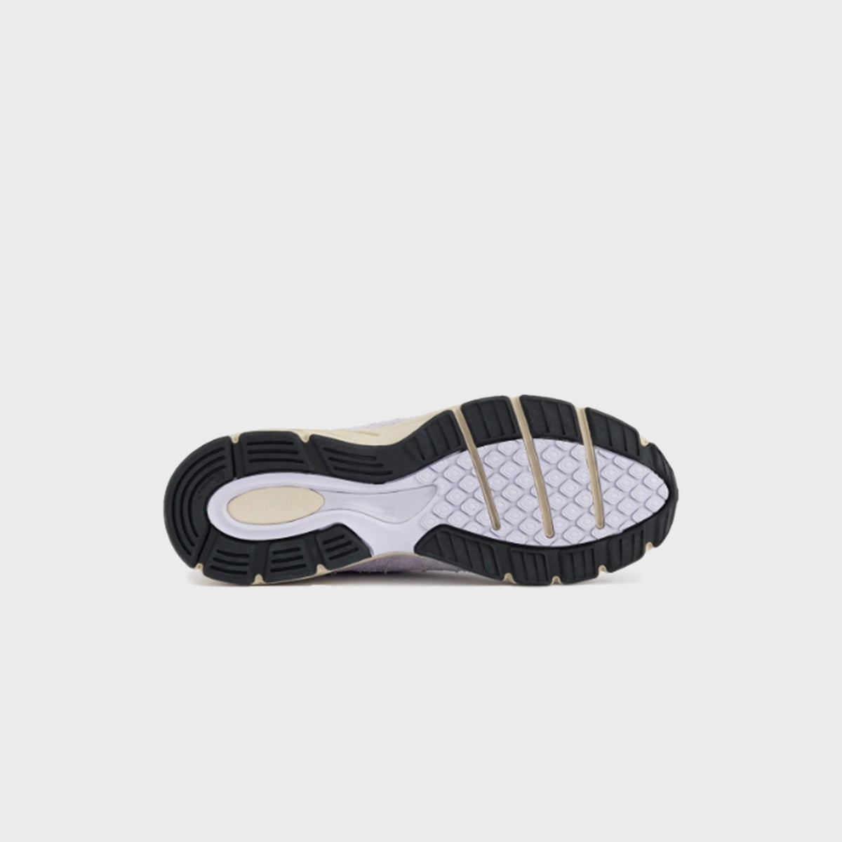 New Balance 990v4 Made in USA sneaker, outsole tread view of pair with cream midsole and black rubber