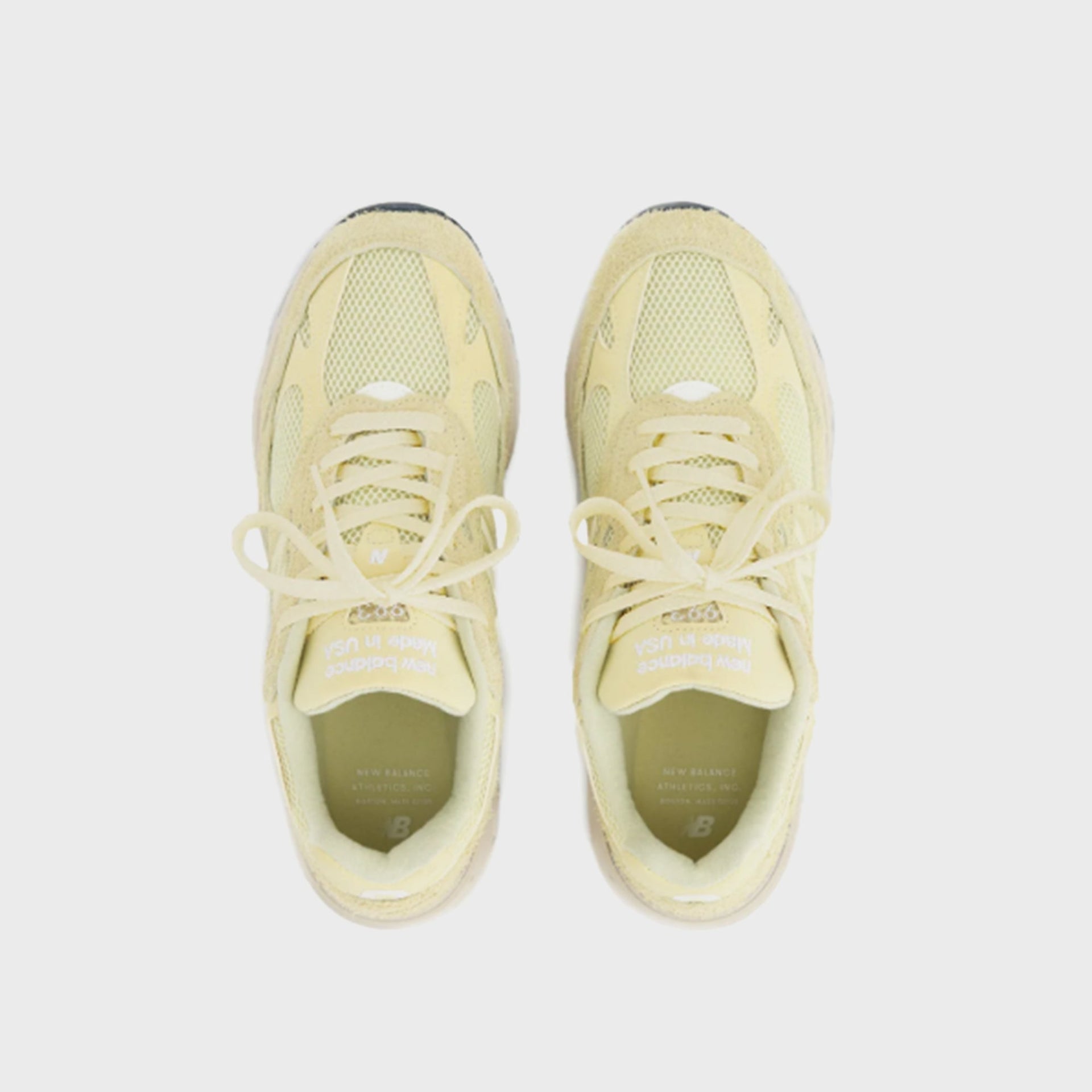 New Balance 993 Made in USA sneaker in pale yellow suede and mesh, top-down view of pair