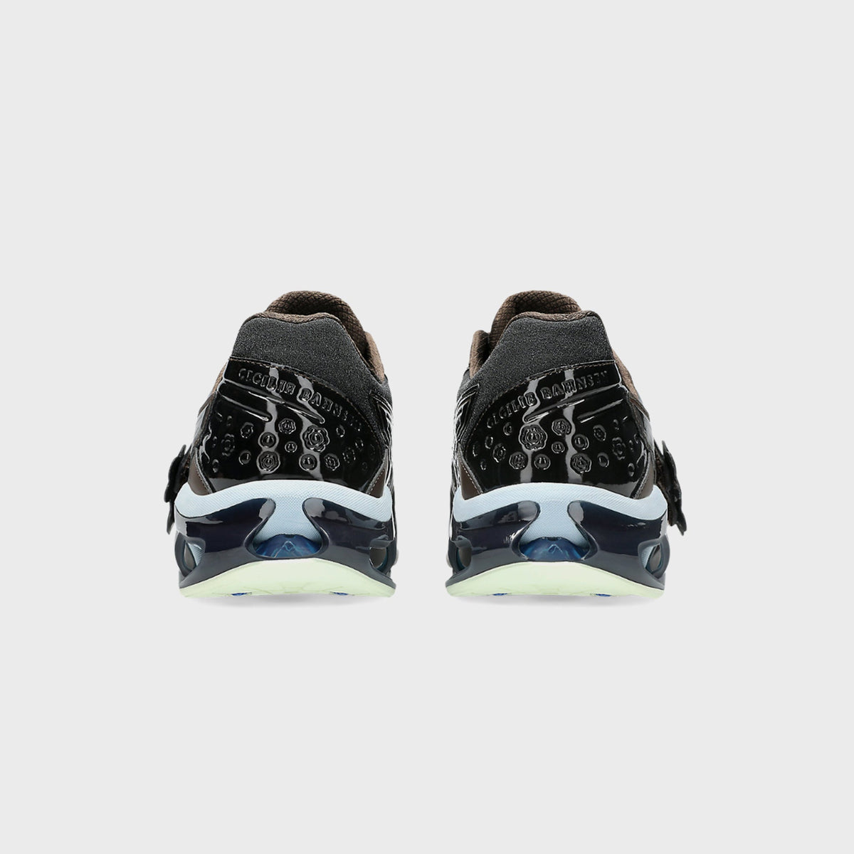 Heel view of ASICS x Cecilie Bahnsen GEL-KINETIC FR pair with embossed Cecilie Bahnsen script and debossed floral patent leather