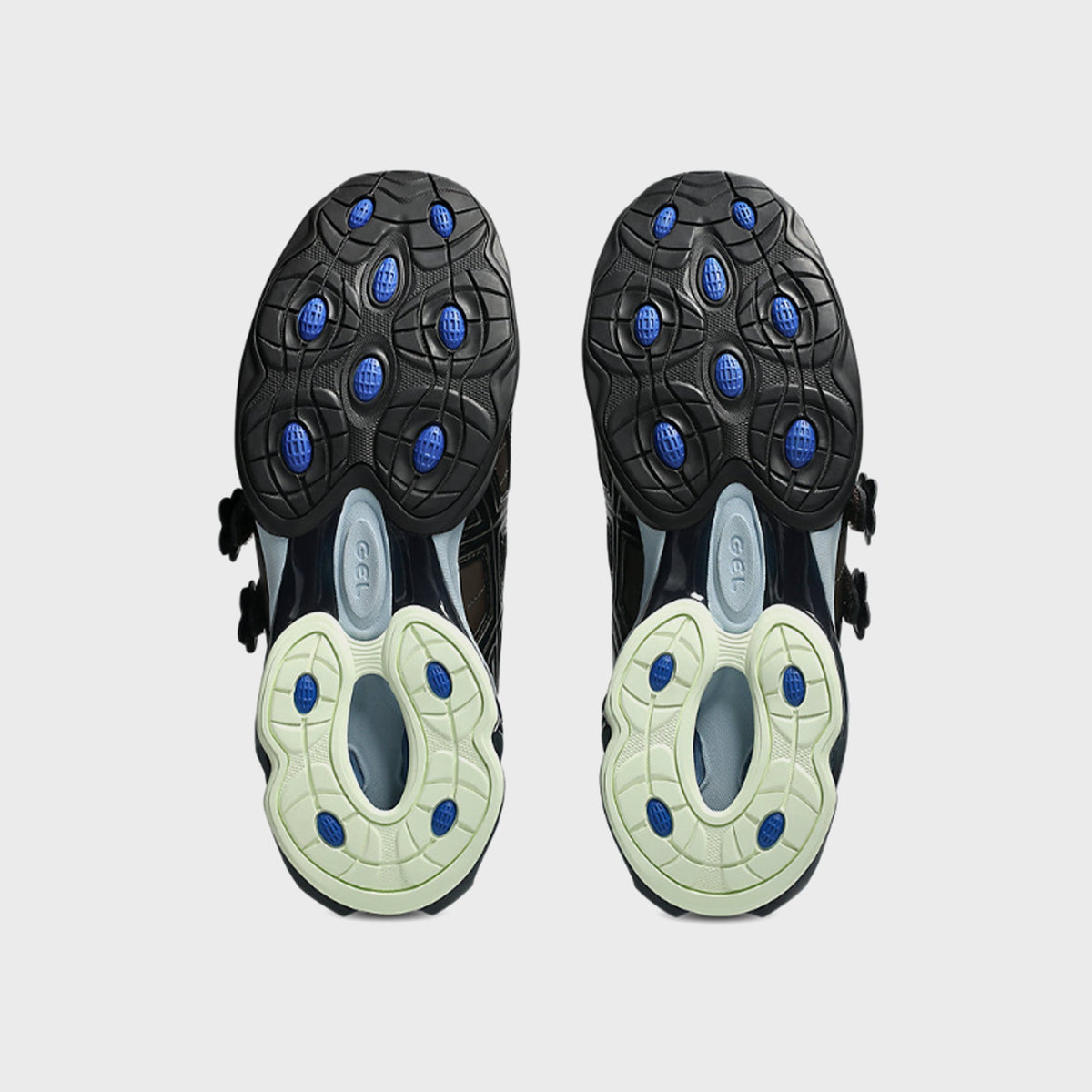 Outsole view of ASICS x Cecilie Bahnsen GEL-KINETIC FR pair showing cobalt blue GEL cushioning pods and glow-green rubber lugs