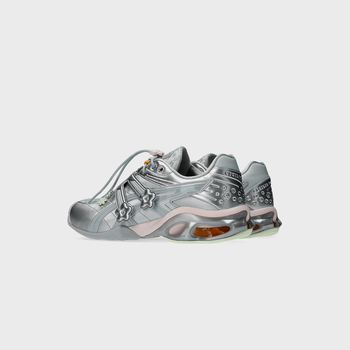 Rear three-quarter view of ASICS x Cecilie Bahnsen GEL-KINETIC FR pair in silver with pink midsole trim