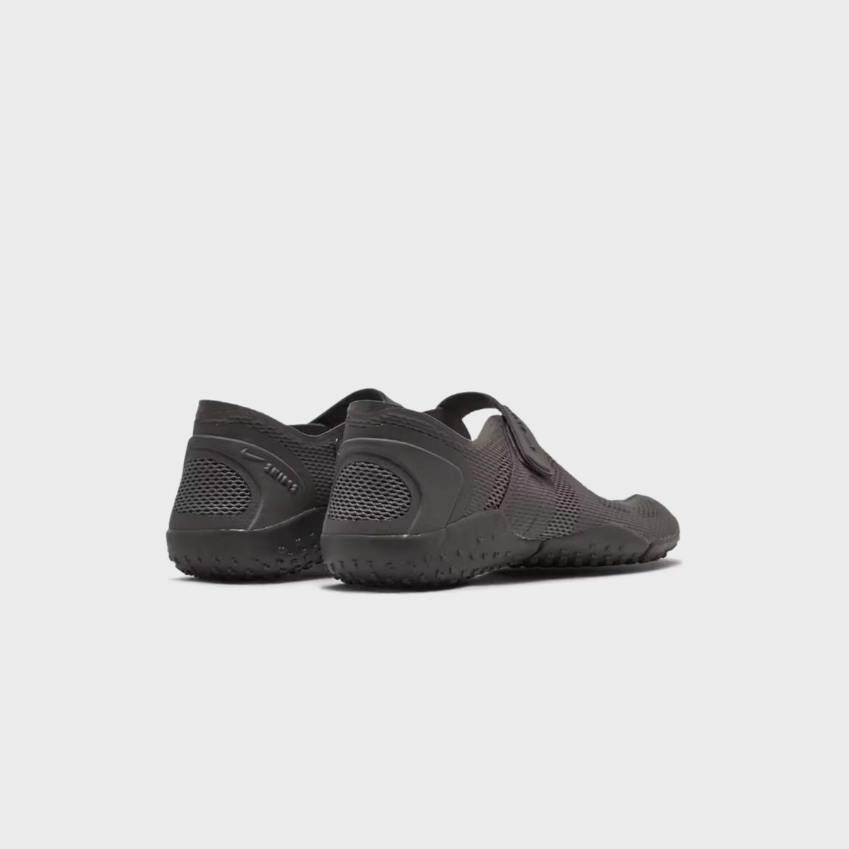 NikeSKIMS Rift 2 Tone Mesh sneakers in Cave Stone, rear three-quarter view of the pair on a tonal lugged outsole
