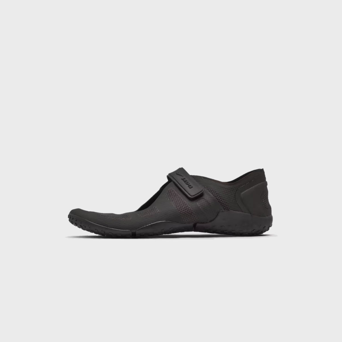NikeSKIMS Rift 2 Tone Mesh sneaker in Tar Black, side view highlighting the adjustable strap over the mesh upper