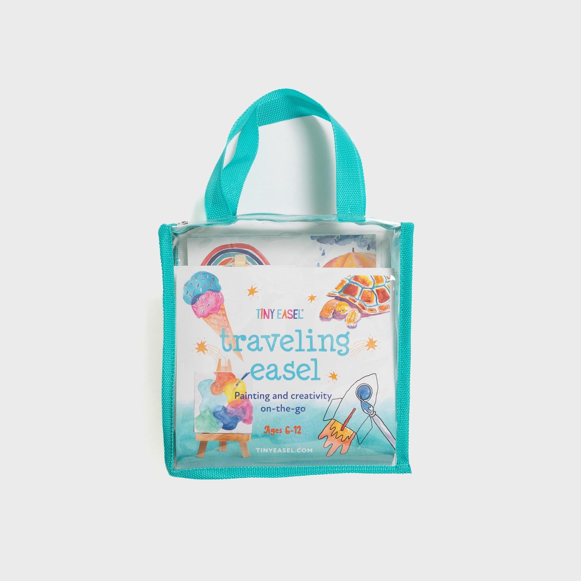 Tiny Easel Traveling Easel kit in clear tote with teal trim, front view with mini wooden easel and watercolor painting cards, ages 6-12