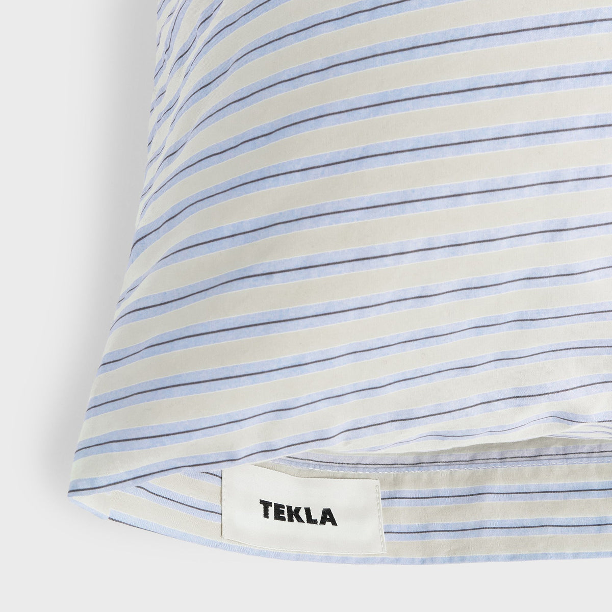 Tekla Percale Pillow Sham in Flint Stripes, close-up of corner with woven TEKLA label