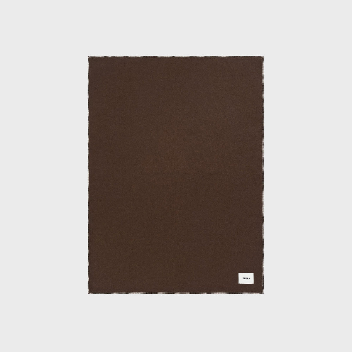 Tekla Lambswool Blanket in Walnut, close-up of the solid dark brown wool fabric