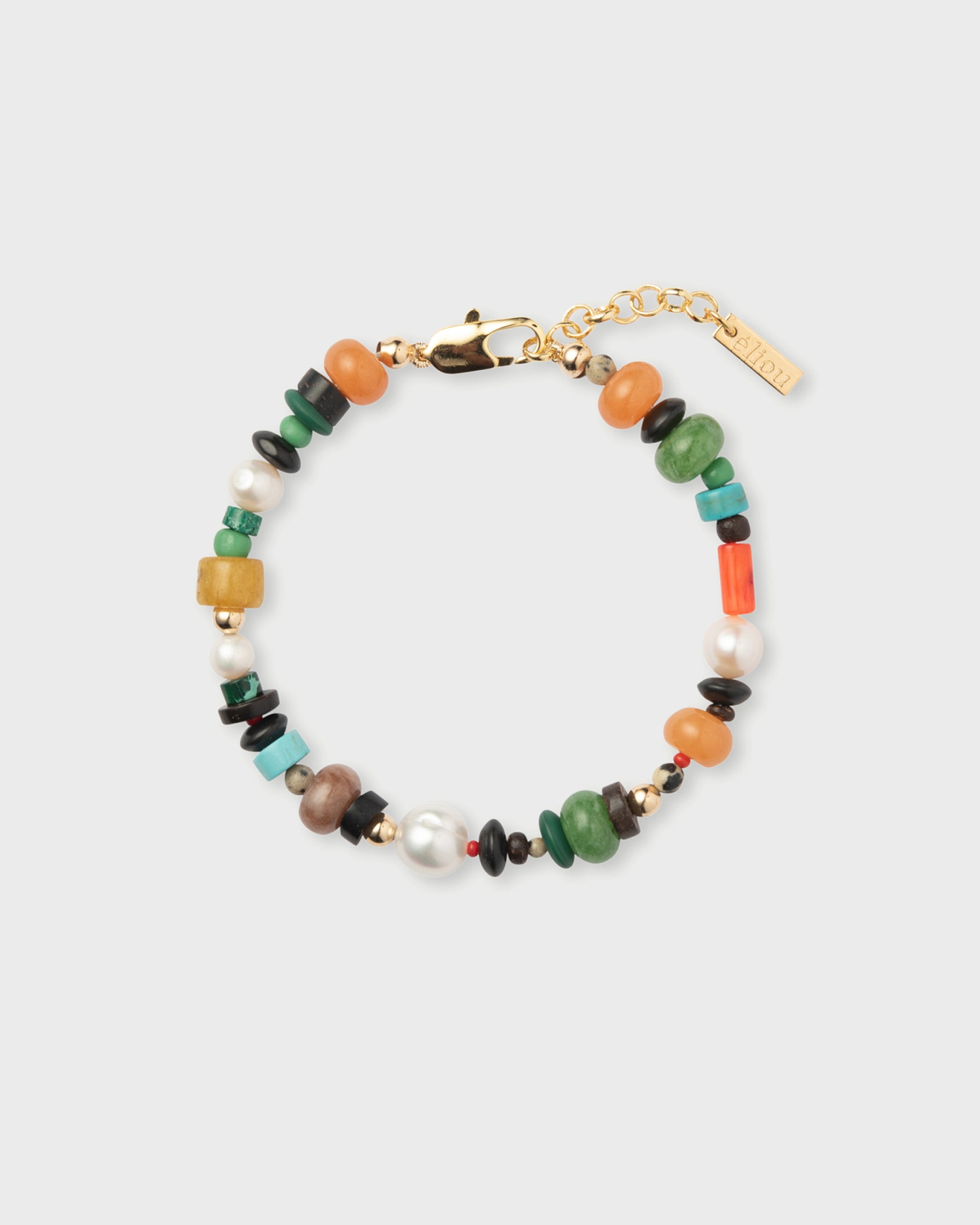 Eliou multicolor beaded bracelet with pearl, turquoise, coral, and jade stone beads on a gold-tone chain, flat lay