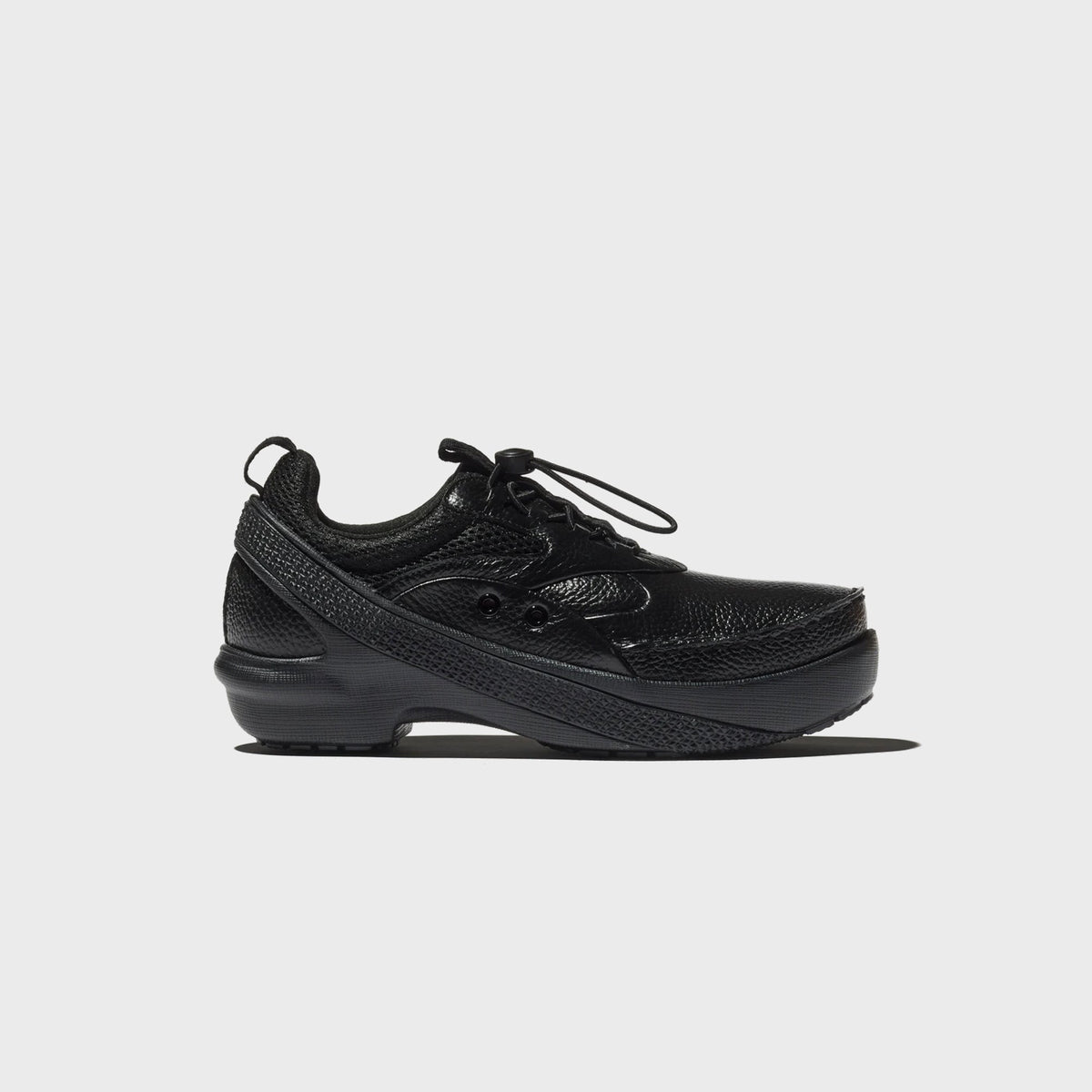 Crocs x Kiko Kostadinov VAALS in black, side profile of pebbled leather and mesh upper with bungee toggle laces and tonal sole