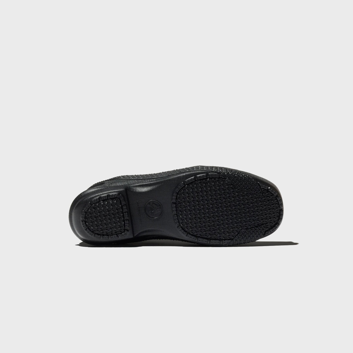 Crocs x Kiko Kostadinov VAALS in black, outsole view showing molded diamond traction pattern and Crocs logo at the arch