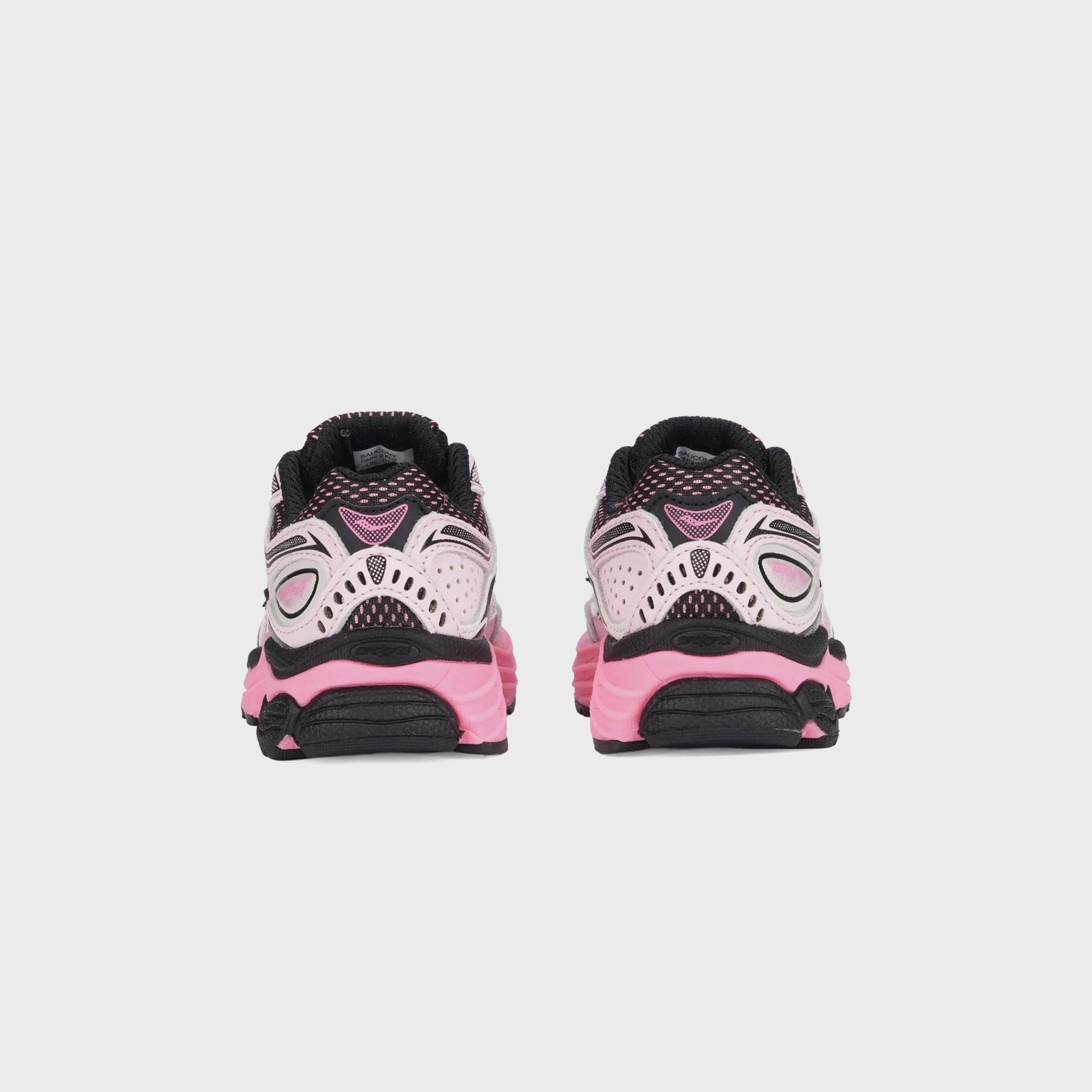 Saucony TD Omni 9 KDZ sneaker pair heel view with pink midsole and black outsole