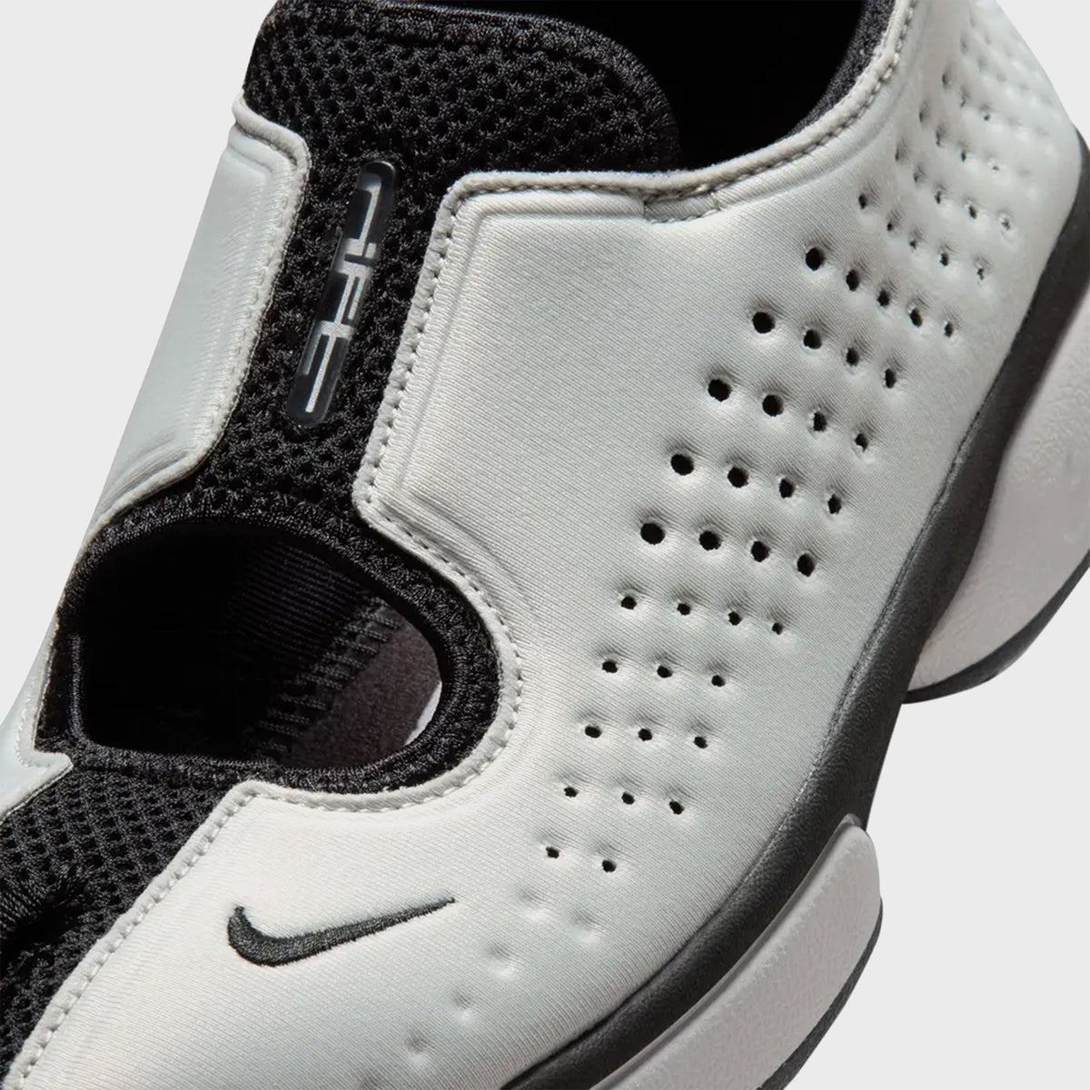 Nike Rift 2 sneaker in Metallic Silver, close-up of the perforated toe box and Swoosh detail