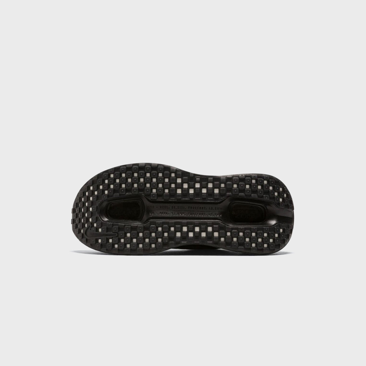 Nike Vomero Premium SP outsole in black showing checkerboard rubber tread pattern, bottom view