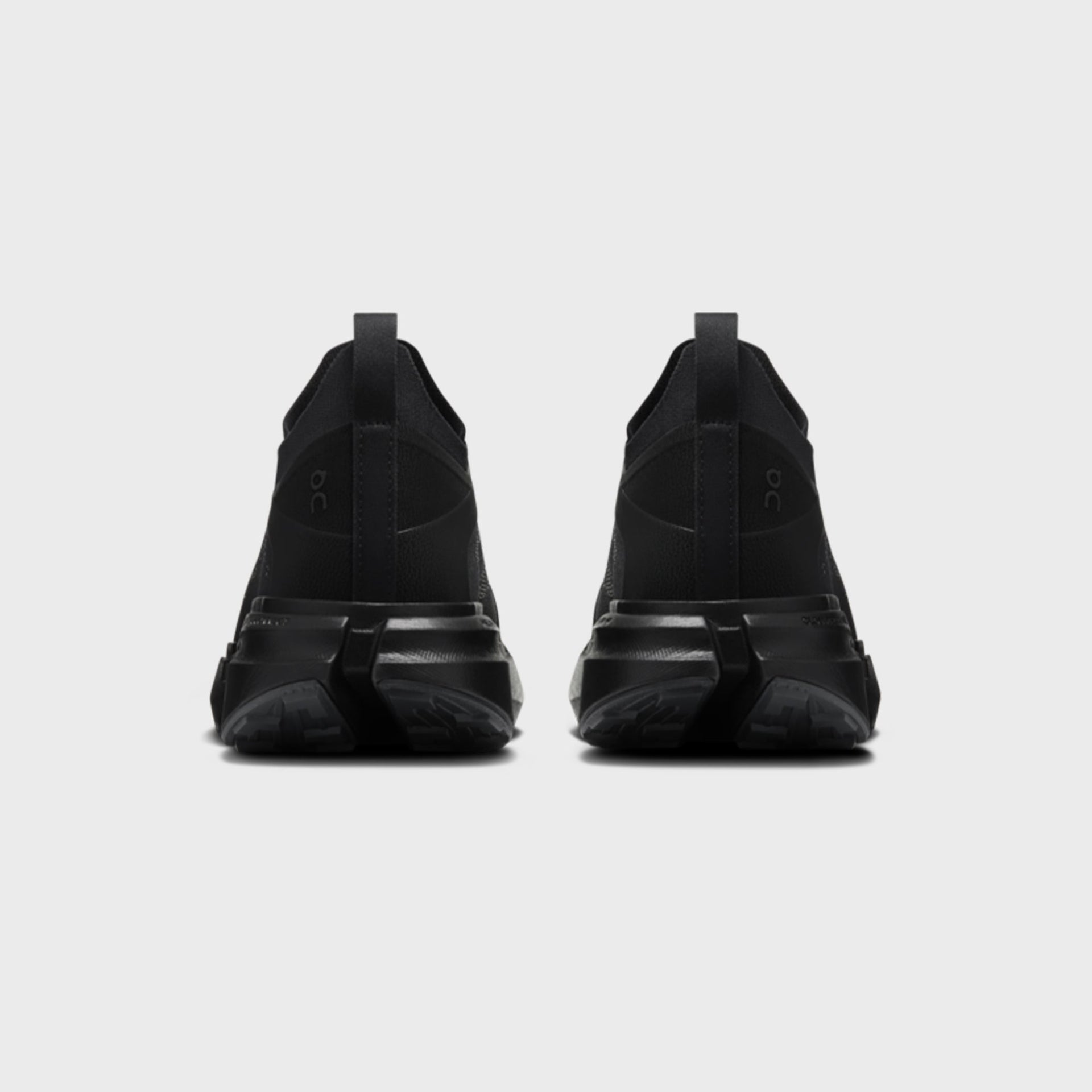On x Post Archive Faction Cloudsoma sneaker in all-black, rear heel view of pair