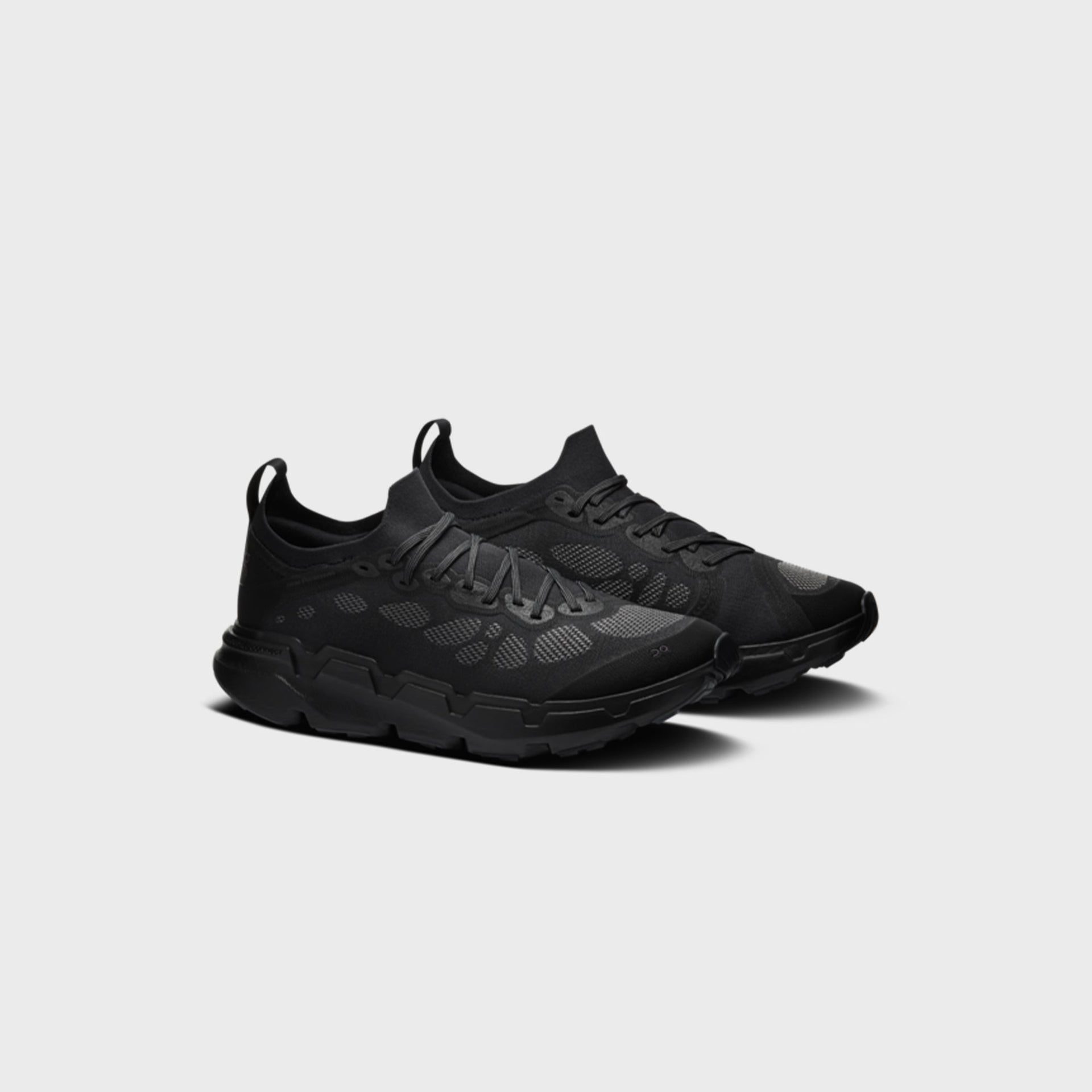 On x Post Archive Faction Cloudsoma sneaker in all-black, front three-quarter view of pair