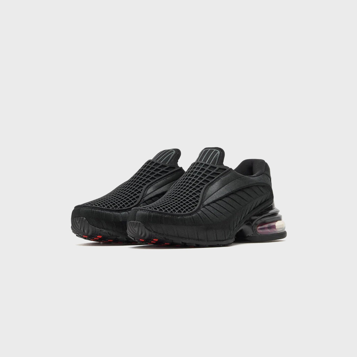 Nike WMNS Air Max Dolce Black / Sport Red pair, front three-quarter view of black grid-mesh slip-on with red outsole accents
